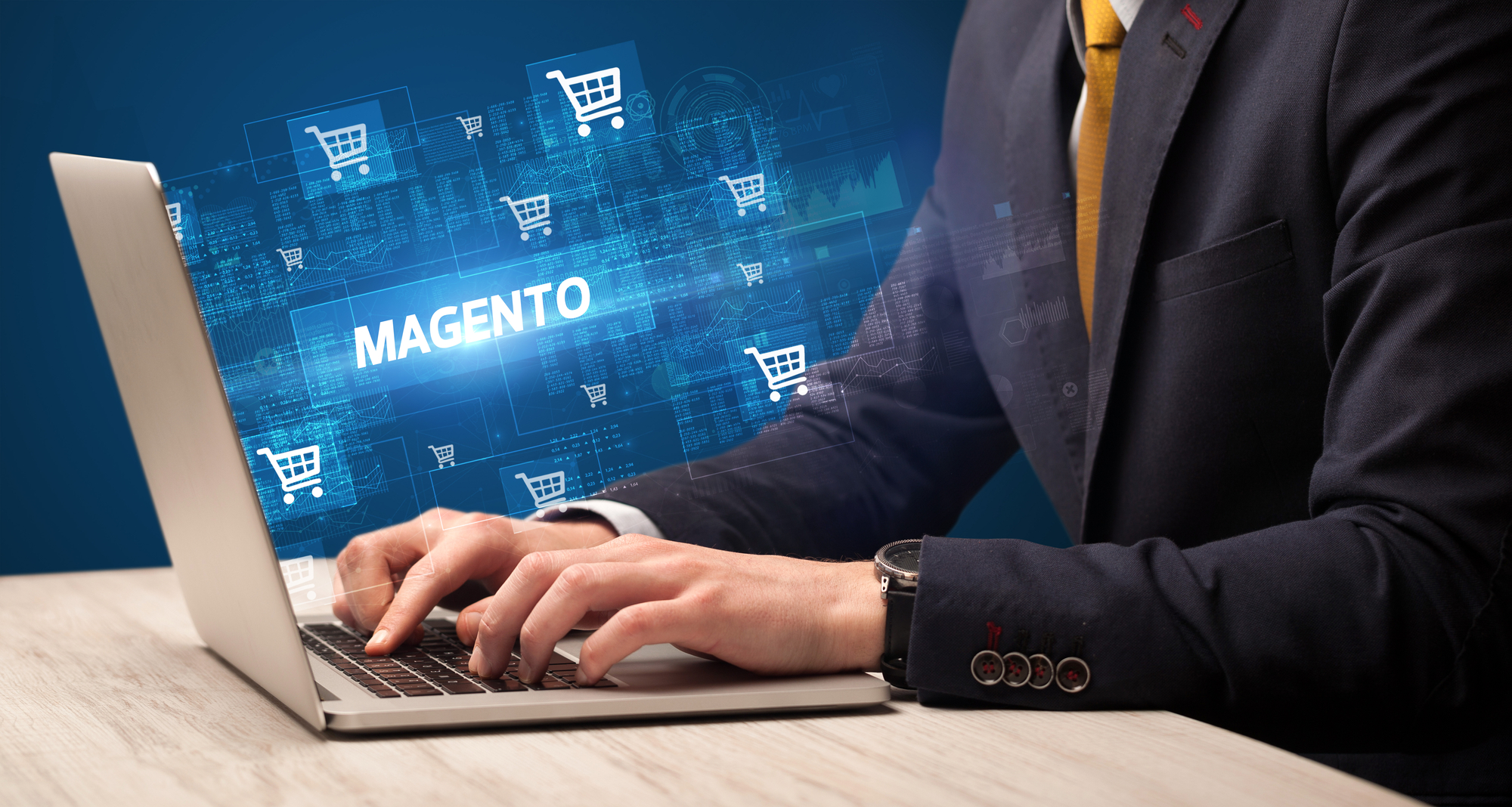 Businessman working on laptop with MAGENTO inscription, online shopping concept